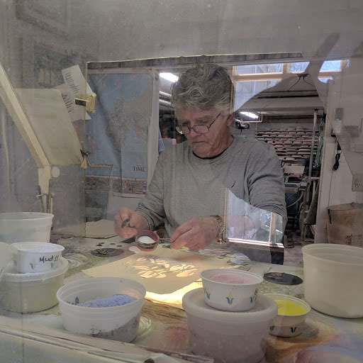 An artisan works on the glass.